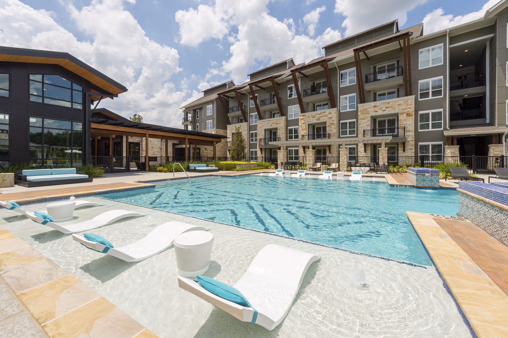Luxurious poolside lounge area at Creekside Park The Grove Apartments for relaxation and leisure