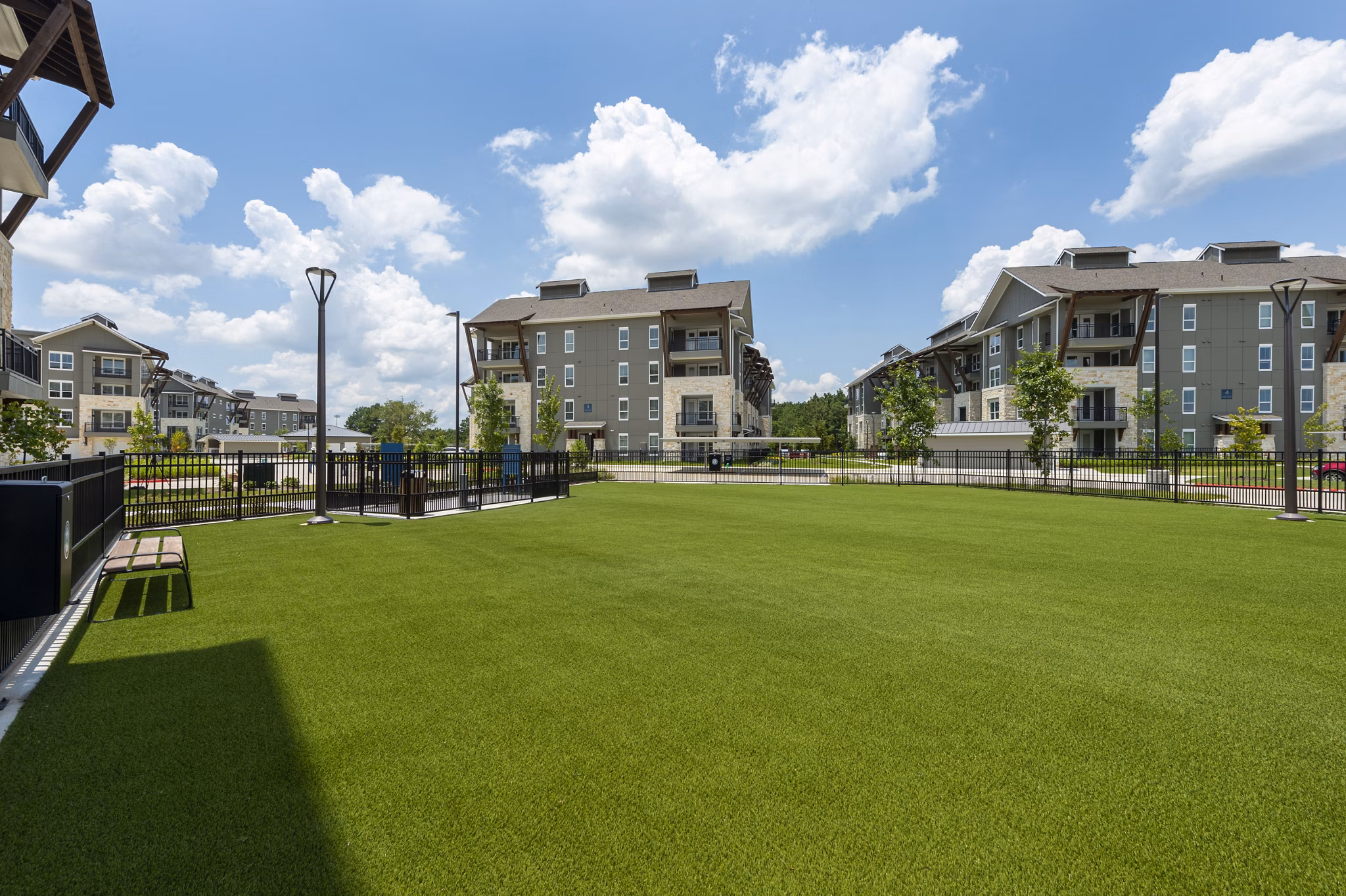 Off-leash dog park at Creekside Park The Grove Apartments, perfect for pet-friendly luxury living