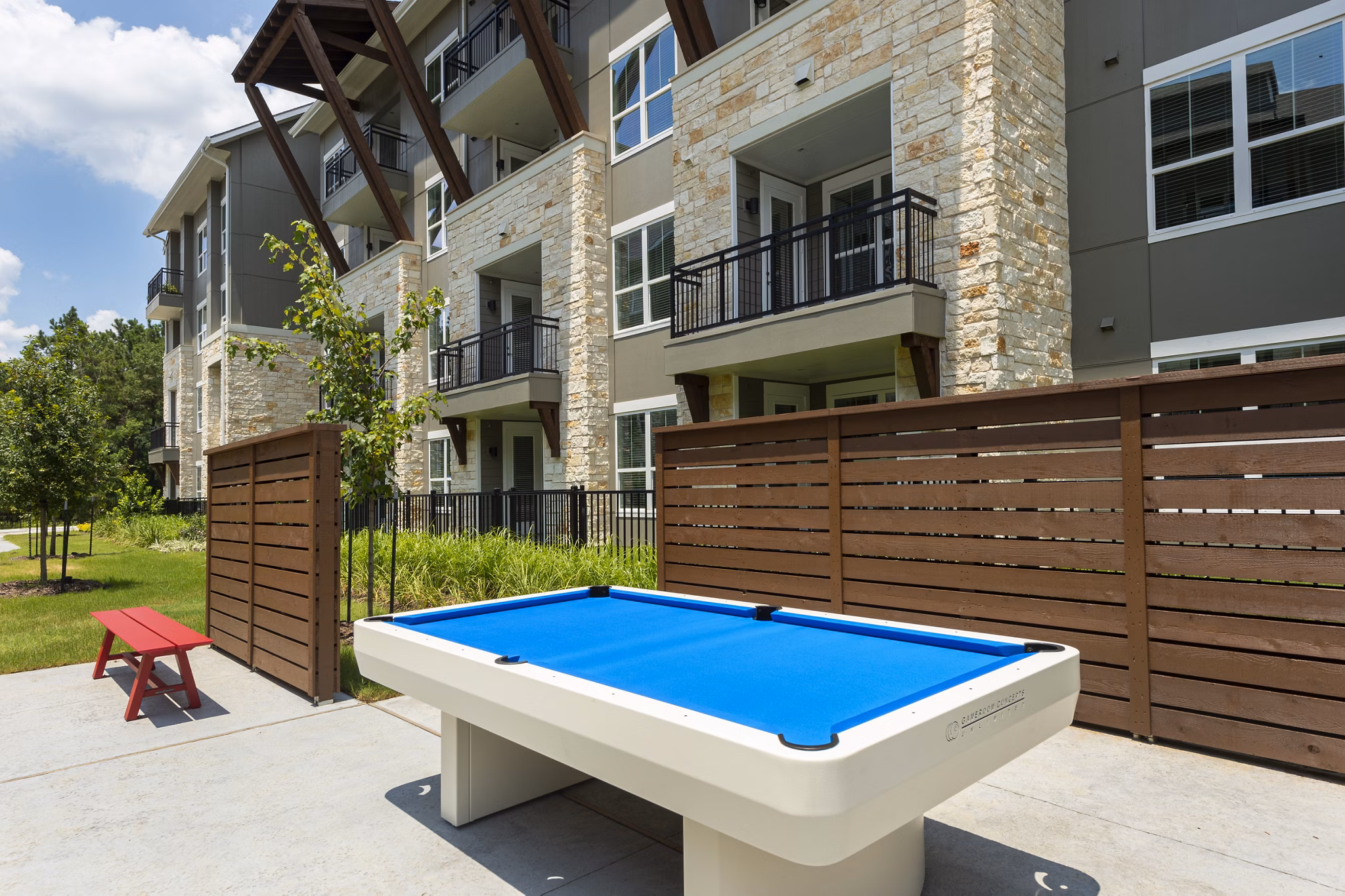Serene courtyard with lush greenery at Creekside Park The Grove Apartments, a tranquil retreat for residents in a luxury setting