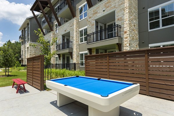 Serene courtyard with lush greenery at Creekside Park The Grove Apartments, a tranquil retreat for residents in a luxury setting