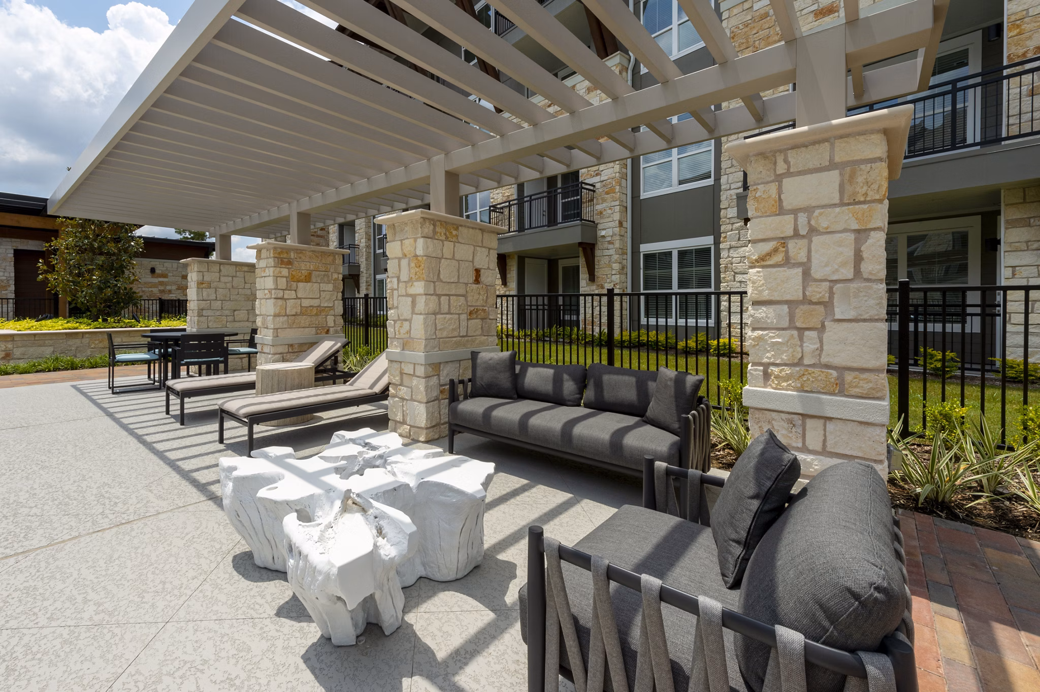 Relaxing patio with lush greenery at Creekside Park The Grove Apartments, a luxury community by Greystar in a serene setting