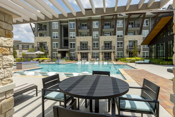 Modern outdoor patio with cozy seating area at Creekside Park The Grove Apartments