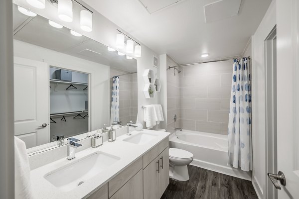 Luxurious bathroom featuring a freestanding tub and marble finishes at Creekside Park The Residences apartments