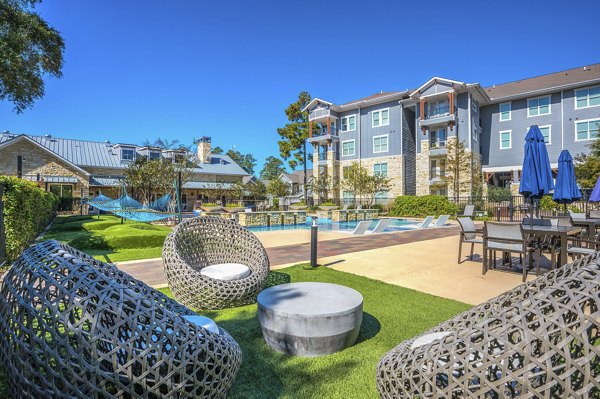 Courtyard with lush gardens and seating at Creekside Park The Residences luxury apartments