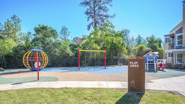 Playground at Creekside Park The Residences with colorful slides and swings, perfect for family recreation in our luxury apartment community