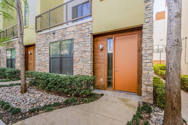 Modern luxury apartments with stone and stucco in a beautifully landscaped setting
