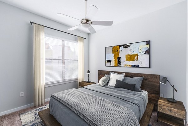 Cozy bedroom with plush bedding and modern decor at The Dylan Apartments