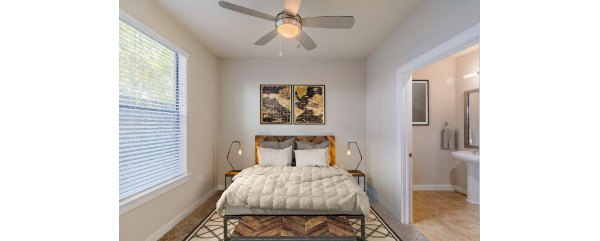 Elegant bedroom with modern decor in The Dylan Apartments, a luxury property managed by Greystar