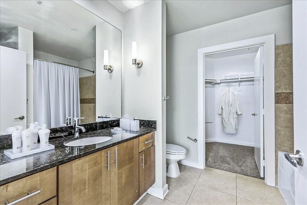 Modern bathroom featuring sleek fixtures and marble countertops at The Dylan Apartments
