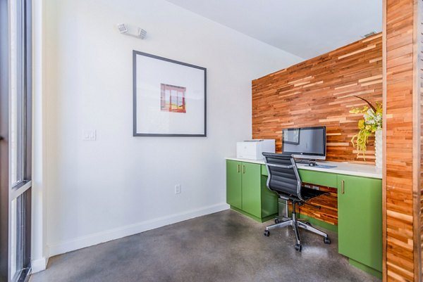 Business center with modern workstations at The Dylan Apartments, offering residents a productive space to work and collaborate