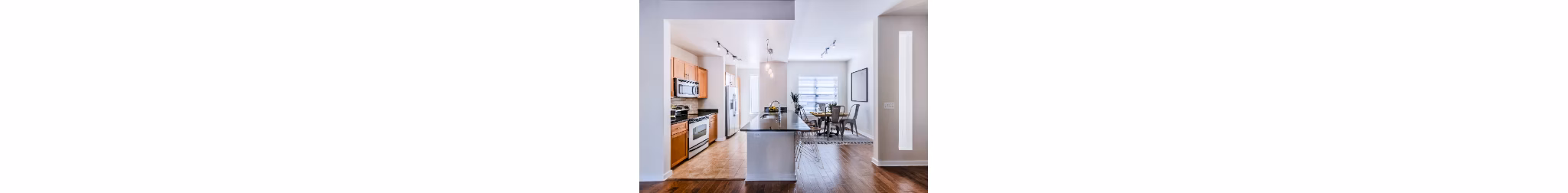 Dining room with elegant decor and large windows at The Dylan Apartments