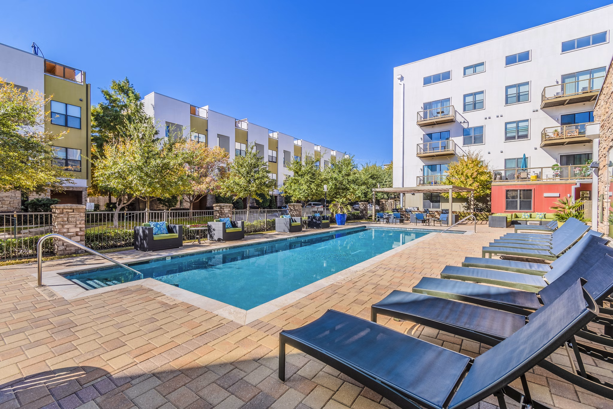 Sparkling outdoor pool oasis at The Dylan Apartments, offering luxury relaxation for residents