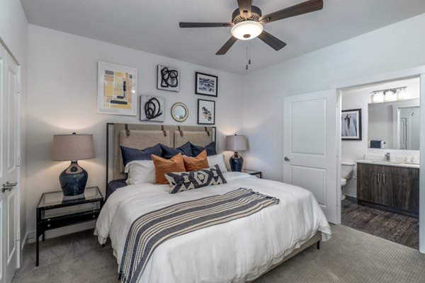 Lakeside Row Apartments: Cozy bedroom with modern decor and natural lighting