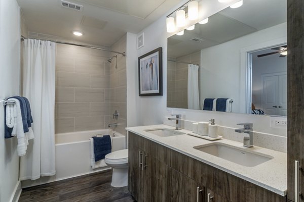 Modern bathroom with sleek fixtures and marble finishes at Lakeside Row Apartments