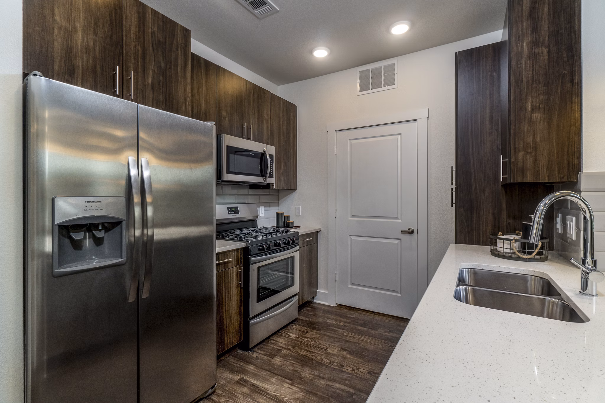 Modern kitchen with stainless steel appliances at Lakeside Row Apartments