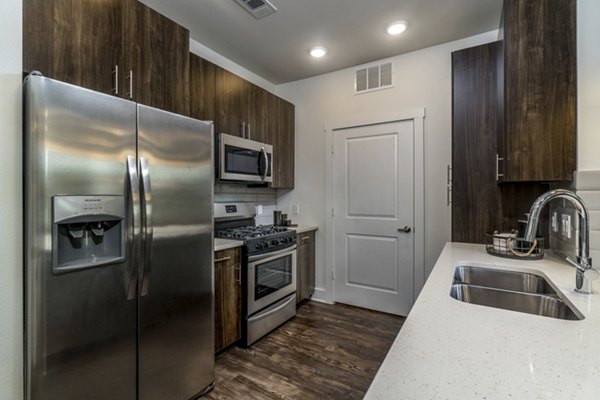 Modern kitchen with stainless steel appliances at Lakeside Row Apartments