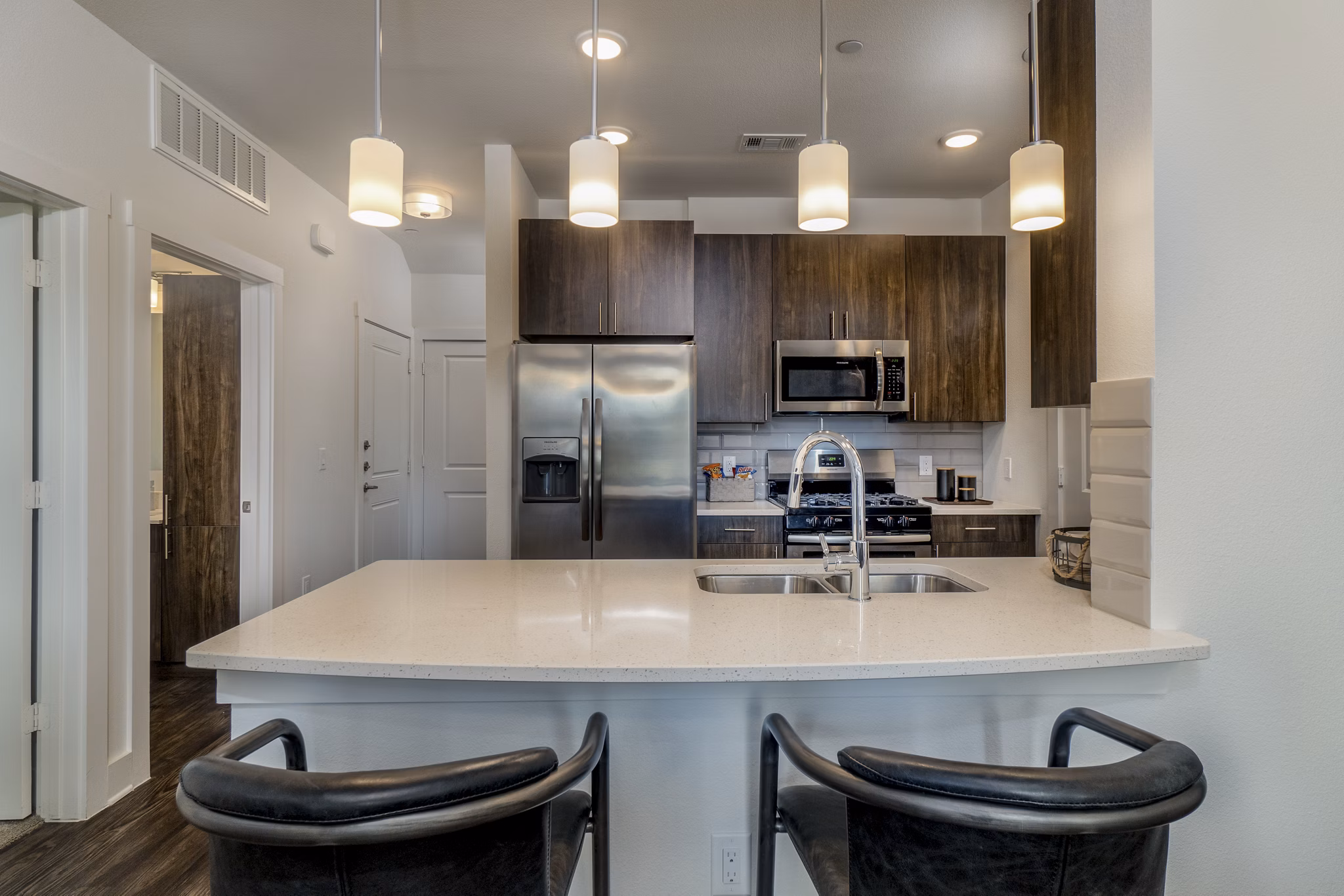 Modern kitchen with stainless steel appliances at Lakeside Row Apartments, luxury living by the water