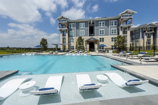 Rooftop pool with lounge chairs at Lakeside Row Apartments offering relaxing waterside luxury living