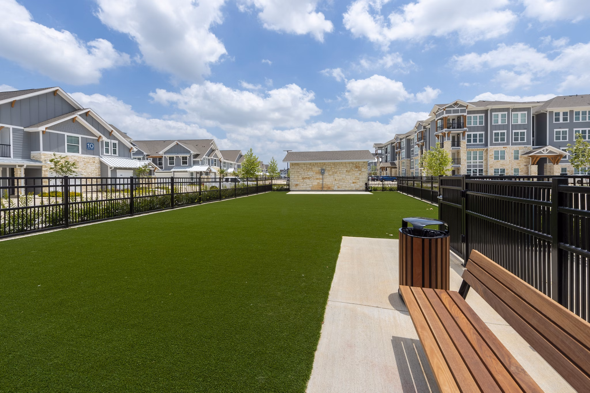 Dog park with agility equipment at Lakeside Row Apartments, a Greystar property