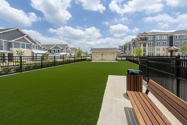 Dog park with agility equipment at Lakeside Row Apartments, a Greystar property