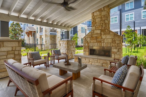Modern patio with a fire pit at Lakeside Row Apartments, luxury outdoor amenity for relaxation and socializing