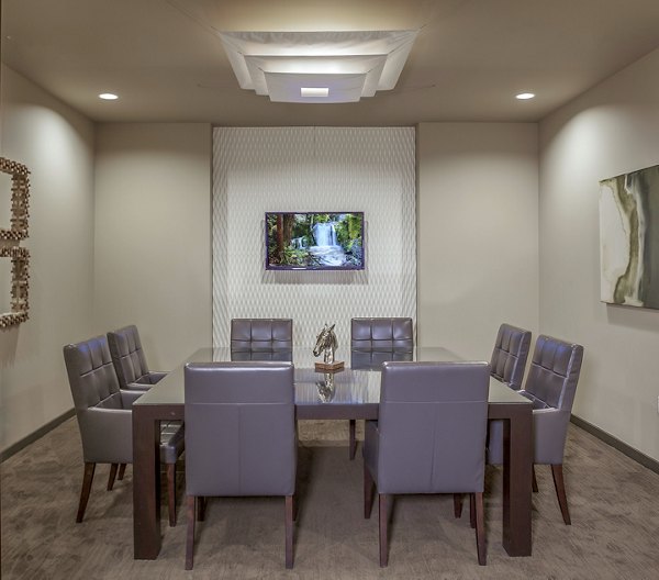 Meeting facility with modern seating and video conferencing equipment at The Millennium Six Pines Apartments