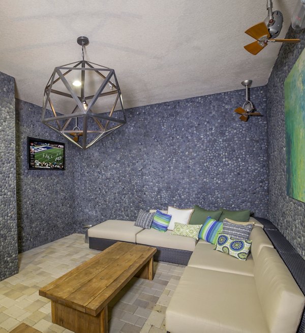 Modern clubhouse with luxurious seating and game area at The Millennium Six Pines Apartments