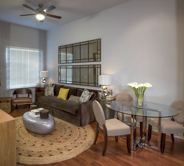 Spacious living room with modern dÃ©cor at The Millennium Six Pines Apartments