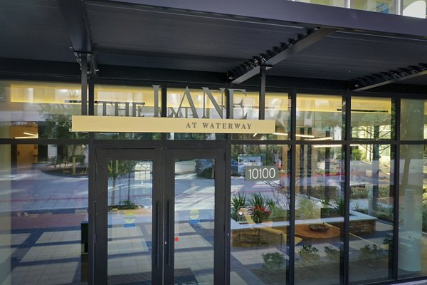 Signage for The Lane at Waterway Apartments, featuring modern design and luxury living amenities in a vibrant community