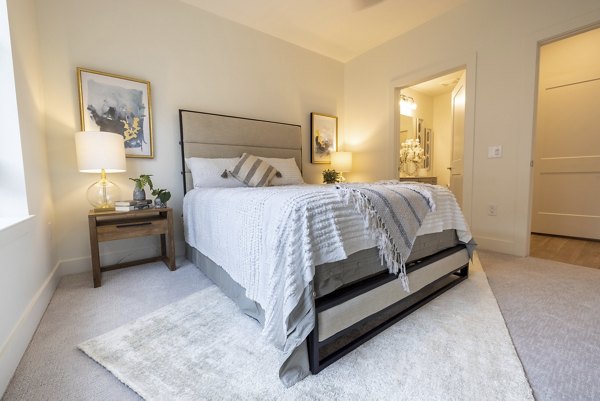 Cozy bedroom with modern decor at The Lane at Waterway Apartments