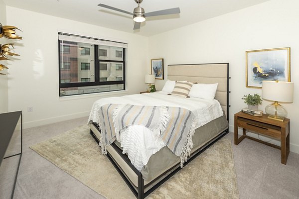 Bedroom featuring elegant decor and natural light in The Lane at Waterway Apartments