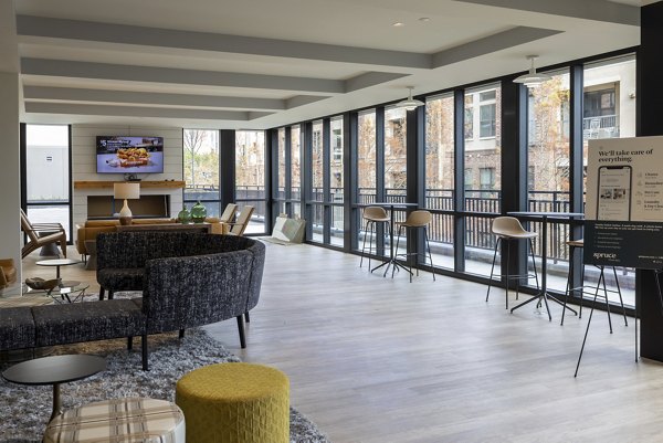 Modern clubhouse with lounging areas at The Lane at Waterway Apartments