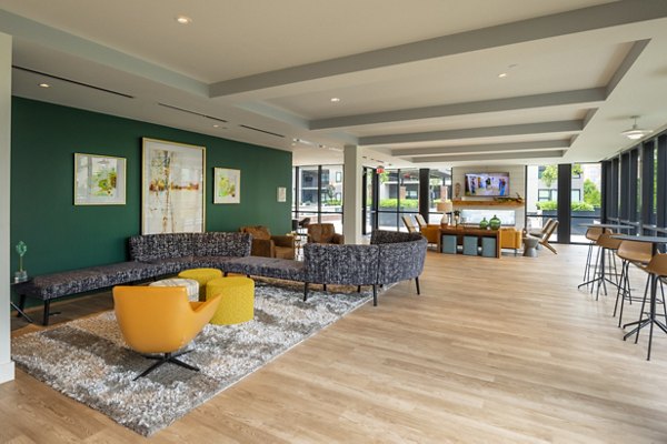 Clubhouse with modern design and pool tables at The Lane at Waterway Apartments, offering luxury living and social spaces