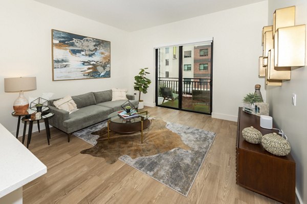 Spacious living room with modern decor at The Lane at Waterway Apartments