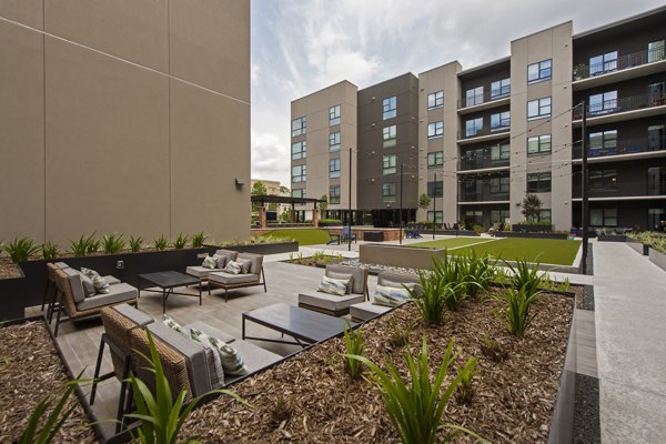 The Lane at Waterway Apartments: Scenic courtyard with lush greenery, offering a serene outdoor space for residents