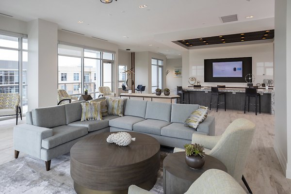 Modern clubhouse with cozy seating and pool tables at Two Lakes Edge Apartments