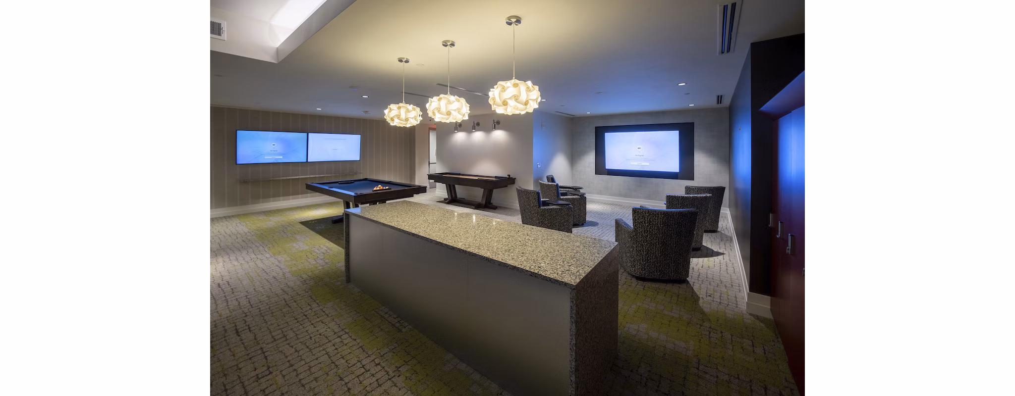 Modern clubhouse with casual seating areas and pool tables at Two Lakes Edge Apartments