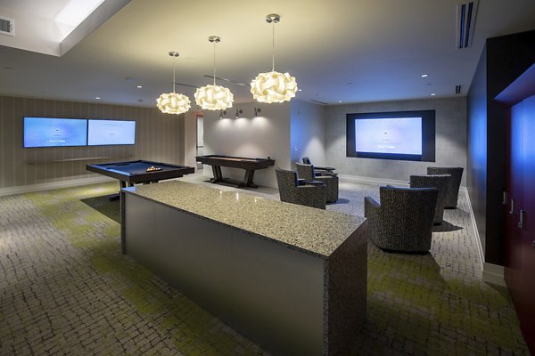 Modern clubhouse with casual seating areas and pool tables at Two Lakes Edge Apartments