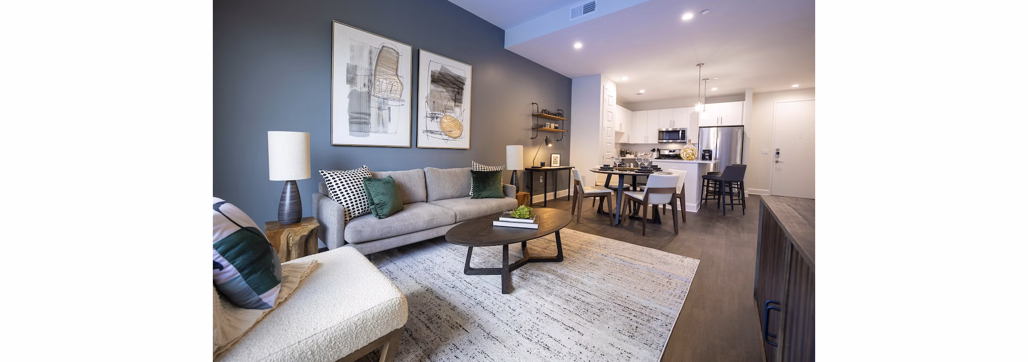 Spacious living room with modern decor and lake views at Two Lakes Edge Apartments