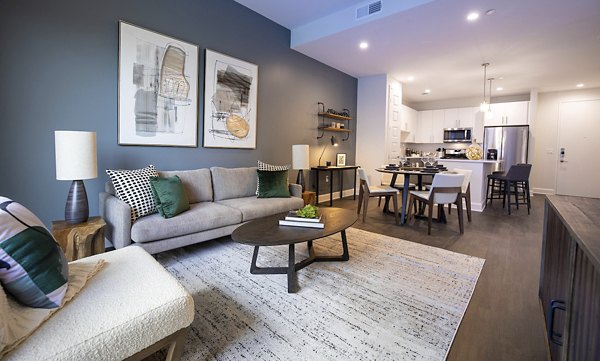 Spacious living room with modern decor and lake views at Two Lakes Edge Apartments