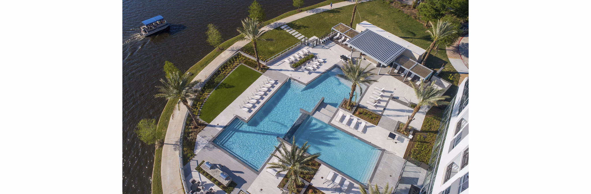 Poolside relaxation area with a modern design at Two Lakes Edge Apartments, perfect for leisure and enjoying sunny days