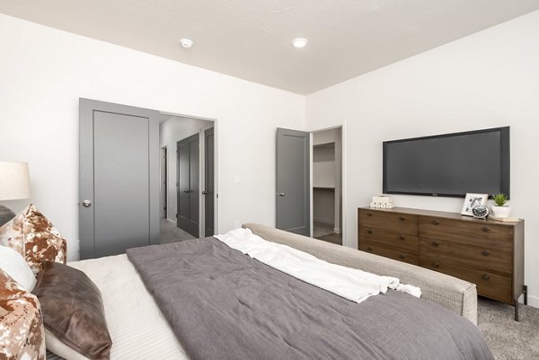 Cozy bedroom with modern furnishings at Black Ridge Cove Apartments, offering luxury living in a serene environment