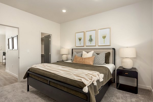Cozy bedroom with modern decor at Black Ridge Cove Apartments offering luxury living