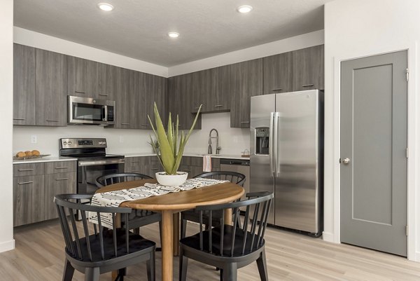 Dining area with modern decor and sleek furniture in Black Ridge Cove Apartments, a Greystar luxury apartment community