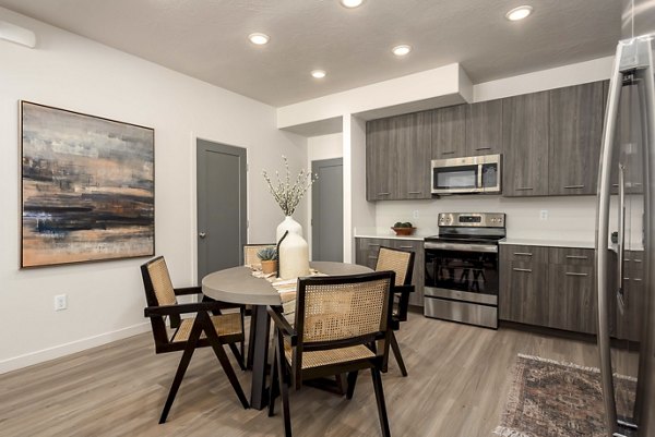Dining area featuring modern decor and large windows in Black Ridge Cove Apartments, a Greystar luxury apartment community