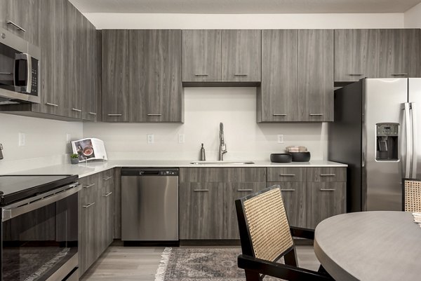 Modern kitchen with stainless steel appliances in Black Ridge Cove Apartments