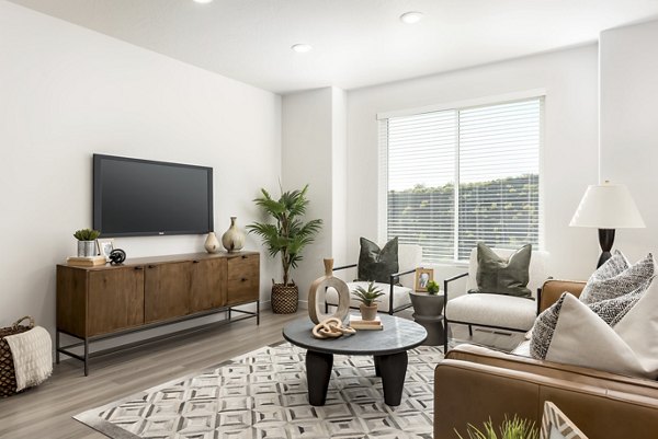 Spacious living room featuring modern decor and natural lighting in Black Ridge Cove Apartments