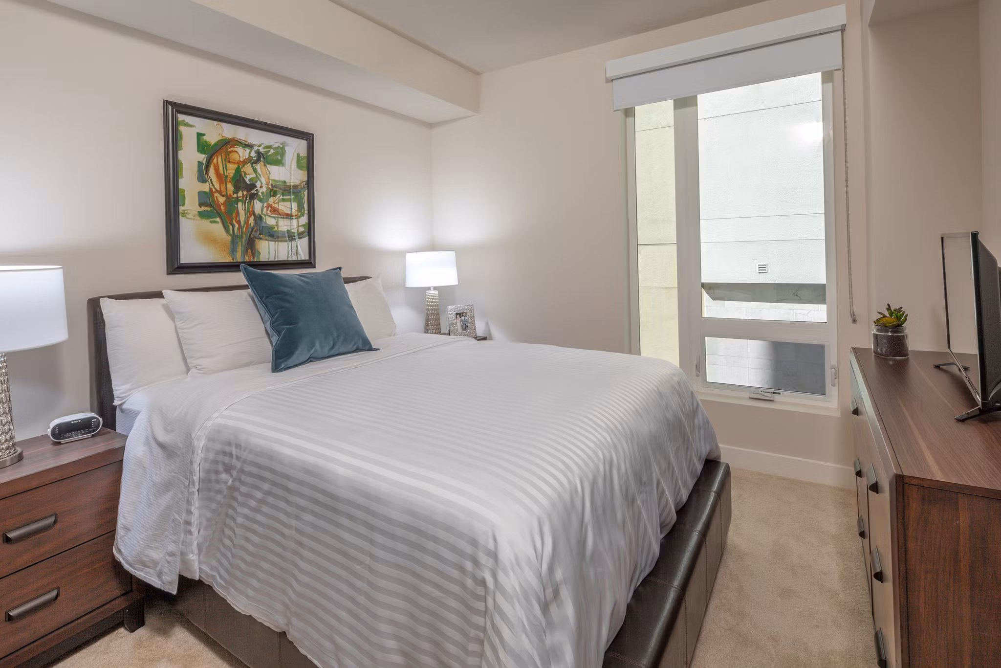 Cozy bedroom with modern decor at mResidences Olympic & Olive Apartments