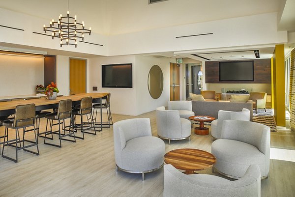 Clubhouse at mResidences Olympic & Olive Apartments featuring modern seating and entertainment area