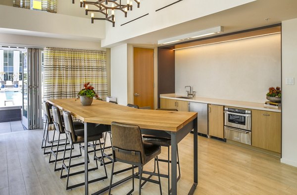 Modern clubhouse at Olympic & Olive Apartments featuring cozy lounge areas and entertainment options